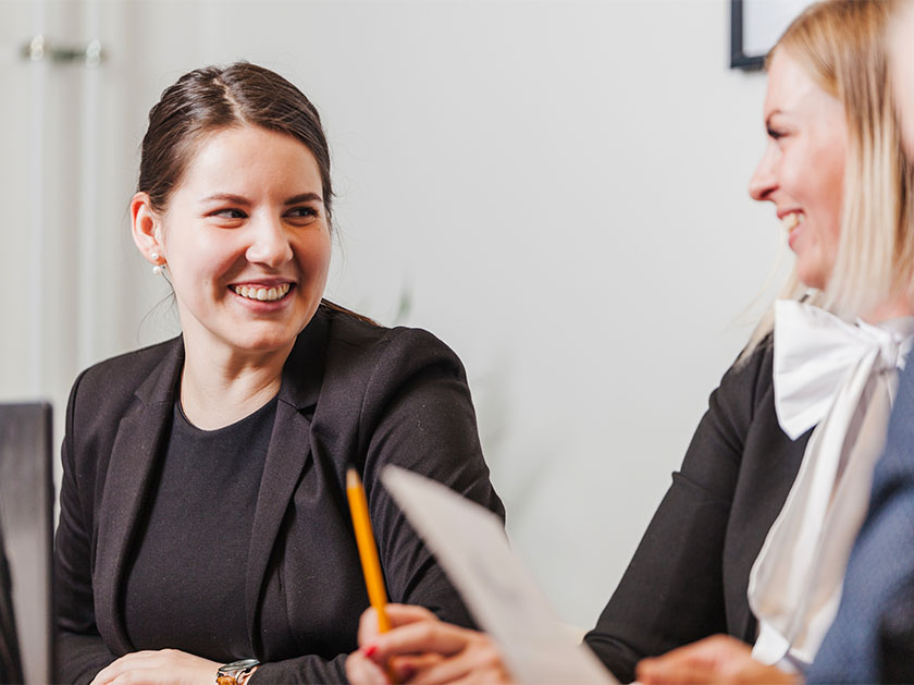 Smiling women wearing suits